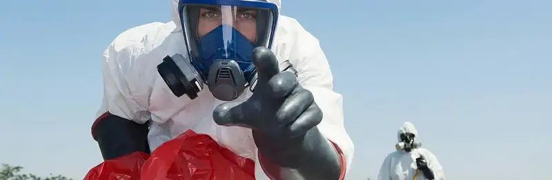 sewage clean up technician wearing protective gear handling biohazard materials in Colorado Springs, CO