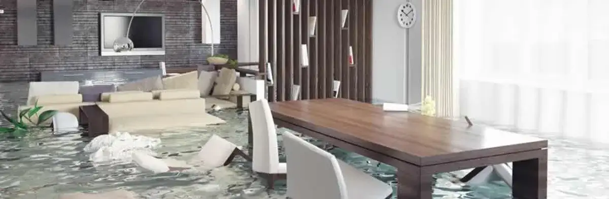 home interior affected by water damage with flooded floors and displaced furniture in Colorado Springs, CO